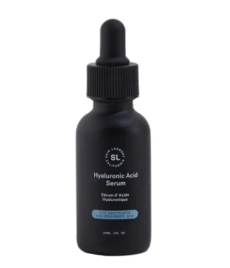 A black dropper bottle of Skin Laundry Hyaluronic Acid Serum with the brand logo and product name visible. The label also indicates "0.5% NIACINAMIDE 0.5% HYALURONIC ACID". The bottle is presented upright against a white background.